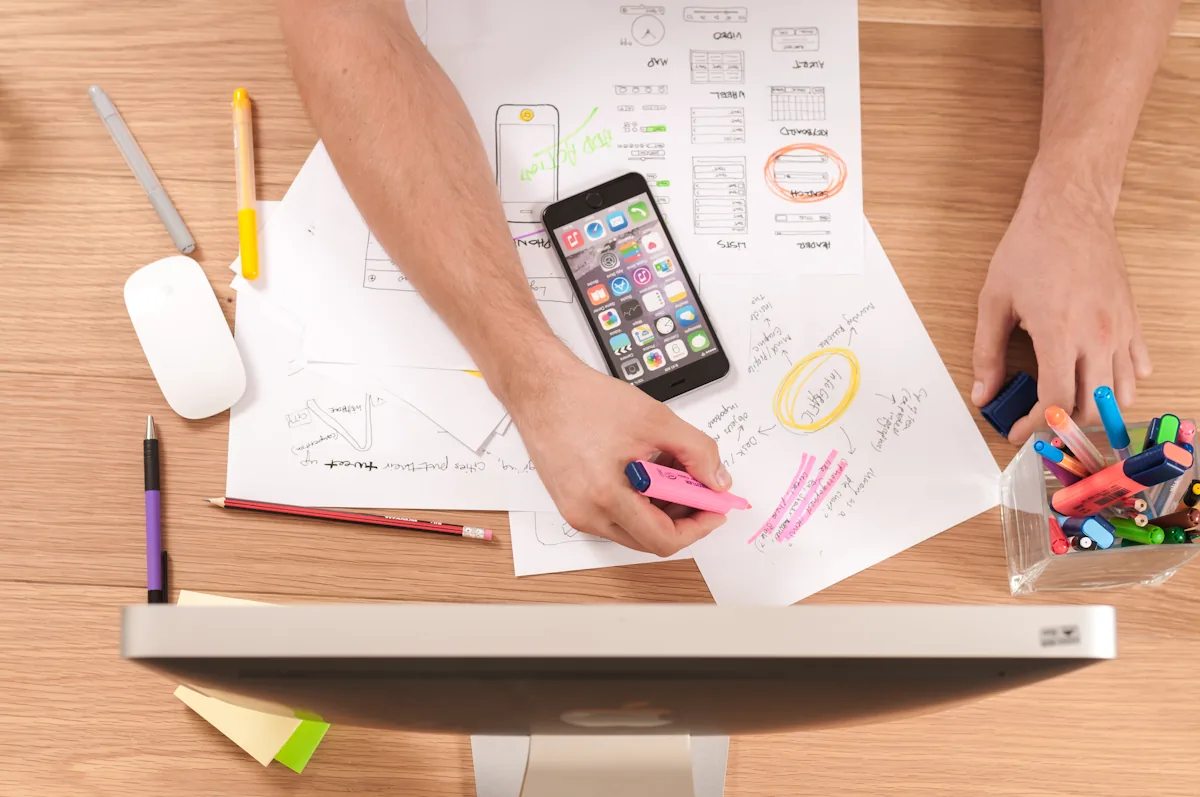A desk laid out with content planning materials and a phone